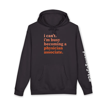 Black hoodie printed with "i can't. i'm busy becoming a physician associate." in orange text and "#PAsGoBeyond" printed vertically down the sleeve