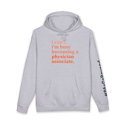 Grey hoodie printed with "i can't. i'm busy becoming a physician associate." in orange text and "#PAsGoBeyond" printed vertically down the sleeve