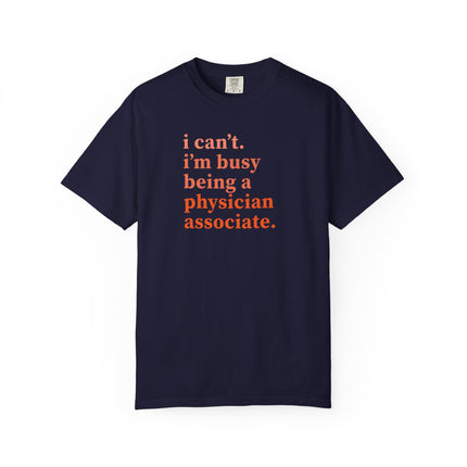 Navy t-shirt printed with "i can't. i'm busy being a physician associate." in orange text.