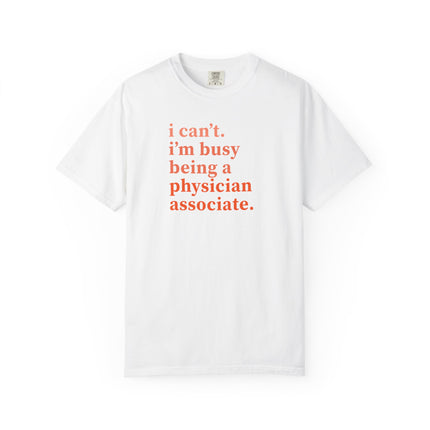 White t-shirt printed with "i can't. i'm busy being a physician associate." in orange text.