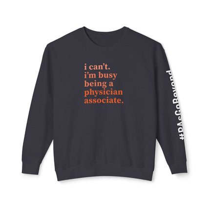 Black crewneck sweatshirt printed with "i can't. i'm busy being a physician associate." in orange text and "#PAsGoBeyond" printed vertically down the sleeve.