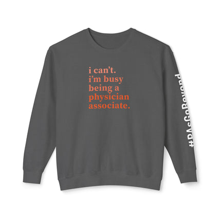 Grey crewneck sweatshirt printed with "i can't. i'm busy being a physician associate." in orange text and "#PAsGoBeyond" printed vertically down the sleeve.