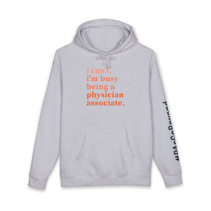 Grey hoodie printed with "i can't. i'm busy being a physician associate." in orange text and "#PAsGoBeyond" printed vertically down the sleeve.