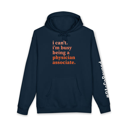 Navy hoodie printed with "i can't. i'm busy being a physician associate." in orange text and "#PAsGoBeyond" printed vertically down the sleeve.