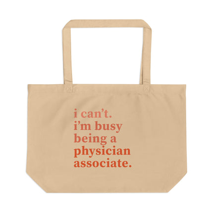 Tan canvas tote bag printed with "i can't. i'm busy being a physician associate." in orange text.