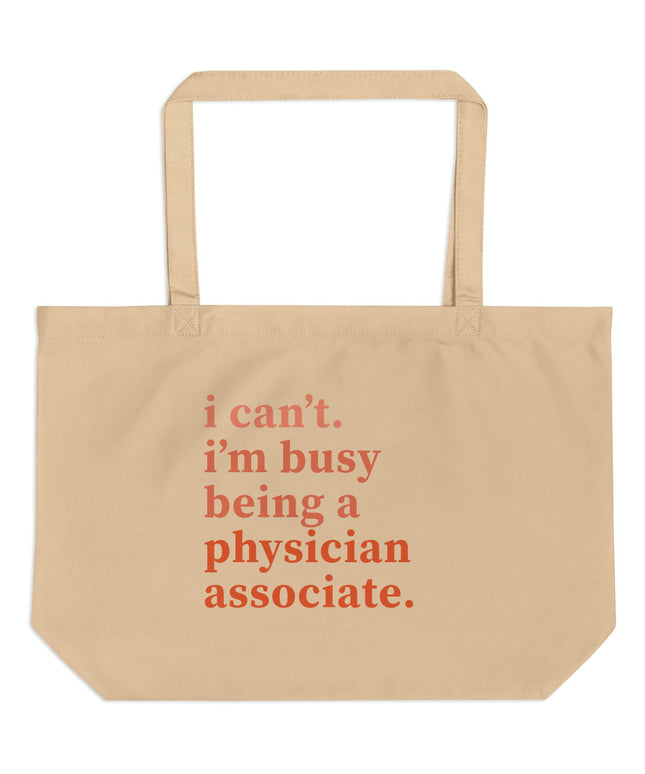 Tan canvas tote bag printed with "i can't. i'm busy being a physician associate." in orange text.