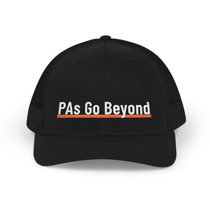 Black trucker hat embroidered with "PAs Go Beyond" in white text, underlined with an orange stripe.
