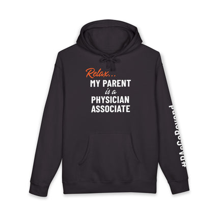 Black hoodie printed with "Relax..." in orange script above "My parent is a Physician Associate" in white text, with "#PAsGoBeyond" printed vertically down the sleeve.